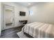 Modern bedroom featuring a striped bedspread, a floating desk, and a walk-out to a balcony at 4070 N Tee Pee Ln, Las Vegas, NV 89129