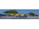 Charming home with a modern design, desert landscaping, and a secure gate, offering privacy and curb appeal at 4070 N Tee Pee Ln, Las Vegas, NV 89129