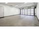 Modern garage featuring a sleek, paneled door and an immaculate concrete floor, ideal for car enthusiasts at 4070 N Tee Pee Ln, Las Vegas, NV 89129