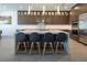 Modern kitchen with a large island, stylish bar stools, and high-end appliances, perfect for entertaining at 4070 N Tee Pee Ln, Las Vegas, NV 89129