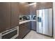 Modern kitchen featuring stainless steel appliances and sleek wooden cabinets at 4070 N Tee Pee Ln, Las Vegas, NV 89129