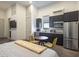 Modern living space featuring a kitchenette with stainless steel appliances and dining area at 4070 N Tee Pee Ln, Las Vegas, NV 89129