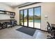 Office with seamless outdoor access features a sleek workspace, built-in storage, and serene views of the pool at 4070 N Tee Pee Ln, Las Vegas, NV 89129