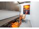 Modern office space with built-in desks, bright orange chairs, and stylish wall art at 4070 N Tee Pee Ln, Las Vegas, NV 89129