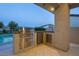 Modern outdoor kitchen with stainless steel grill, sink, and counter space, perfect for entertaining near the pool at 4070 N Tee Pee Ln, Las Vegas, NV 89129