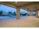 Spacious covered patio overlooking the pool and fire pit, perfect for outdoor entertaining and relaxation at 4070 N Tee Pee Ln, Las Vegas, NV 89129