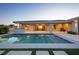 Serene backyard featuring a pool with spa, covered patio and minimalist landscaping, perfect for summer relaxation at 4070 N Tee Pee Ln, Las Vegas, NV 89129