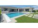 Exterior view of the house and pool, with modern landscaping, a spa, and a built-in outdoor cooking area at 4070 N Tee Pee Ln, Las Vegas, NV 89129