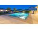 Relaxing backyard oasis with a sparkling pool and a cozy fire pit area for evening gatherings at 4070 N Tee Pee Ln, Las Vegas, NV 89129
