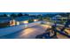A rooftop terrace invites relaxation with cozy Adirondack chairs and panoramic city views under the evening sky at 4070 N Tee Pee Ln, Las Vegas, NV 89129