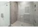 Contemporary bathroom with a glass-enclosed shower and neutral tile at 4070 N Tee Pee Ln, Las Vegas, NV 89129