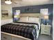Stylized bedroom featuring a plaid blanket, a ceiling fan, and bedside tables with lamps at 4125 Tyrol Way, Las Vegas, NV 89124