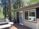 Relaxing deck area featuring outdoor seating and scenic views of the surrounding trees at 4125 Tyrol Way, Las Vegas, NV 89124