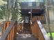 Inviting entrance featuring wooden stairs and a charming porch and mature trees at 4125 Tyrol Way, Las Vegas, NV 89124