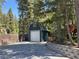 Spacious detached garage with a paved driveway and mature trees at 4125 Tyrol Way, Las Vegas, NV 89124