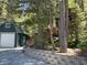 Features a barn style garage and mature trees on the property at 4125 Tyrol Way, Las Vegas, NV 89124