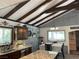 Dining area featuring granite countertops, an island, and a view into an adjacent living space at 4125 Tyrol Way, Las Vegas, NV 89124