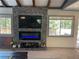 Cozy living room with a stone fireplace and a flat screen television at 4125 Tyrol Way, Las Vegas, NV 89124