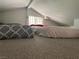 Cozy carpeted loft space with a window for natural light and comfortable resting area at 4125 Tyrol Way, Las Vegas, NV 89124