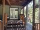 Charming covered porch with comfortable seating and scenic views of the surrounding greenery at 4125 Tyrol Way, Las Vegas, NV 89124