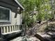 Beautiful yard featuring natural landscaping with stone steps and a tranquil wooded backdrop, with sitting bench at 4125 Tyrol Way, Las Vegas, NV 89124