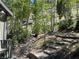 Beautiful yard featuring natural landscaping with stone steps and a tranquil wooded backdrop at 4125 Tyrol Way, Las Vegas, NV 89124