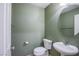Comfortable half bathroom with a pedestal sink and a round mirror at 433 Royal Bridge Dr, Las Vegas, NV 89178