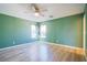 A bright bedroom offers wood-look flooring and two windows allowing ample natural light at 433 Royal Bridge Dr, Las Vegas, NV 89178