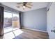 A sunlit bedroom features wood-look flooring and sliding door to a balcony at 433 Royal Bridge Dr, Las Vegas, NV 89178
