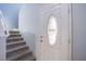 Inviting entryway featuring a carpeted staircase and front door with decorative glass panel at 433 Royal Bridge Dr, Las Vegas, NV 89178