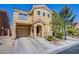 Two-story home with tan stucco, attached garage, and manicured yard is located in a desirable community at 433 Royal Bridge Dr, Las Vegas, NV 89178
