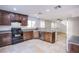 Modern kitchen featuring stainless steel appliances, granite countertops, and dark wood cabinets at 433 Royal Bridge Dr, Las Vegas, NV 89178