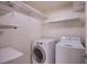 Functional laundry room with a modern washer and dryer, and ample shelving for storage at 433 Royal Bridge Dr, Las Vegas, NV 89178