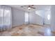 Bright living room with tile flooring, ceiling fan, and large windows for natural light at 433 Royal Bridge Dr, Las Vegas, NV 89178