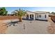 Wide shot of the house from the backyard, featuring desert landscaping and a covered patio at 4410 S Gressa St, Pahrump, NV 89061