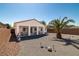 Low-maintenance desert backyard with a palm tree, gravel, and covered patio space at 4410 S Gressa St, Pahrump, NV 89061