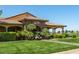 Exterior of the community clubhouse with lush landscaping and golf cart parking at 4410 S Gressa St, Pahrump, NV 89061