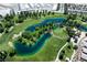 Scenic aerial view of a lush golf course with water features and surrounding homes, perfect for golf enthusiasts at 4410 S Gressa St, Pahrump, NV 89061