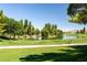 Scenic golf course view with lush green grass, mature trees, and tranquil water features enhancing the landscape at 4410 S Gressa St, Pahrump, NV 89061