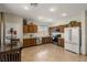 Kitchen featuring wood cabinets, stainless steel appliances, tile floors, and recessed lighting at 4410 S Gressa St, Pahrump, NV 89061