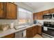 Bright kitchen with oak cabinets, stainless steel appliances, and tile backsplash at 4410 S Gressa St, Pahrump, NV 89061