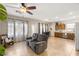 Open-concept living room featuring tile floors, a ceiling fan, and natural light at 4410 S Gressa St, Pahrump, NV 89061