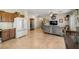 Open concept living room and kitchen with tile floors and stainless steel appliances at 4410 S Gressa St, Pahrump, NV 89061