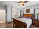 Bedroom with wood floors, a ceiling fan, classic furniture, and ensuite bathroom at 4410 S Gressa St, Pahrump, NV 89061