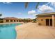 Resort-style pool area with clear blue water, poolside seating, and lush landscaping, creating a serene oasis at 4410 S Gressa St, Pahrump, NV 89061