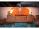 Backyard fire feature with a decorative fountain, creating a warm ambiance by the pool at 4554 Blue Mesa Way, Las Vegas, NV 89129