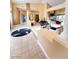 Expansive living room showcasing high ceilings, recessed lights, tile flooring, and open layout at 4554 Blue Mesa Way, Las Vegas, NV 89129