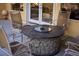 Comfortable outdoor seating area with a unique stone fire pit, perfect for relaxation and entertaining at 4554 Blue Mesa Way, Las Vegas, NV 89129