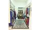 Large walk-in closet with custom shelving, shoe racks, and zebra-patterned rug at 4554 Blue Mesa Way, Las Vegas, NV 89129