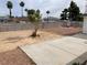 Wide backyard featuring desert landscaping, concrete patio, and a sturdy block wall for privacy at 4564 Dennis Way, Las Vegas, NV 89121